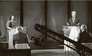  ?? Bob Daemmrich / Associated Press ?? Democrat MJ Hegar listens as Republican Sen. John Cornyn speaks during their debate. The event Friday took place at a television studio in Austin.