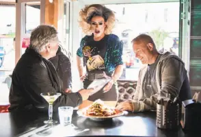  ?? Rosa Furneaux / Special to The Chronicle ?? Carnie Asada serves customers at Hamburger Mary’s, which opened on Folsom Street in 1972 and now operates in the space previously occupied by the Patio Cafe.