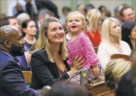  ?? Rich Pedroncell­i Associated Press ?? ASSEMBLYWO­MAN Buffy Wicks, a freshman Democrat, and daughter Josephine, 2, look at the gallery at the start of the new session.