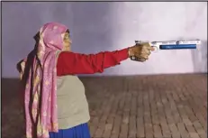  ?? SMITA SHARMA/THE NEW YORK TIMES ?? Chandro Tomar, 89, practices shooting with an air pistol in a shooting range at her residence in Johri, India, Feb. 14, 2021.