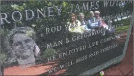  ?? (File Photo/ap/mel Evans) ?? Pat Wotton (left) is reflected in September 2012 in a memorial to her husband, Rodney
James Wotton, as she sits with Dorothy Greene (second left), Jean Wotton, Rodney’s mother, and Eunice Saporito (right), in Middletown, N.J. The marker for Rodney Wotton is one of 37 in the Middletown World Trade Center Memorial Gardens for those from the town in central New Jersey who died in the attack on the World Trade Center in 2001.