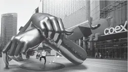  ?? (Gangnam District
Office) ?? A COMPUTER-generated image shows two giant fists overlapped in the style of the song's signature dance move.