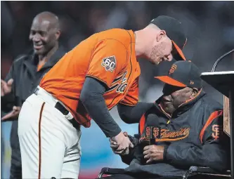  ?? ASSOCIATED PRESS FILE PHOTO ?? Giants pitcher Will Smith, left, shakes hands with Baseball Hall of Famer Willie McCovey after winning the 2018 Willie Mac award in September. McCovey, who played 19 seasons for the Giants, died Wednesday.