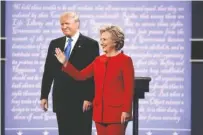  ?? DAMON WINTER/THE NEW YORK TIMES ?? Hillary Clinton and Donald Trump take the stage for their first presidenti­al debate at Hofstra University in Hempstead, N.Y., on Monday.