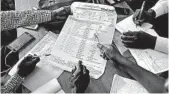  ?? JEROME DELAY/AP ?? Officials tally presidenti­al ballots Friday in Kinshasa, Congo, where the first results are expected Sunday.