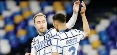  ?? Reuters ?? ↑
Inter Milan’s Christian Eriksen celebrates with a team-mate after scoring a goal against Napoli on Sunday.