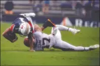  ?? The Associated Press ?? TAKEDOWN: Auburn wide receiver Anthony Schwartz (1) stretches for extra yards as he is tackled by Arkansas defensive back Hudson Clark (17) during the first quarter of Saturday’s game in Auburn, Ala.