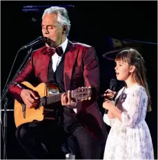  ??  ?? Andrea Bocelli performs in concert with daughter Virginia at Hegra, Saudi Arabia, in April. The father of three (pictured with wife Veronica and Virginia, far left) says he has tried to pass on values he learnt from his father, adding it is important for his children to “find their own road for themselves”