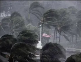  ?? DAVID GOLDMAN — THE ASSOCIATED PRESS ?? An American flag is torn as Hurricane Irma passes through Naples, Fla., Sunday.