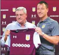  ?? AARON CHOWN/PA VIA AP ?? New Aston Villa signing John Terry (right) poses with manager Steve Bruce during Monday’s media conference in Birmingham, England.