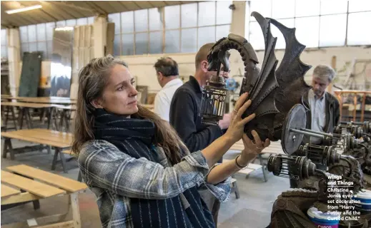  ??  ?? Wings and Things Christine Jones eyes a set decoration from “Harry Potter and the Cursed Child.”