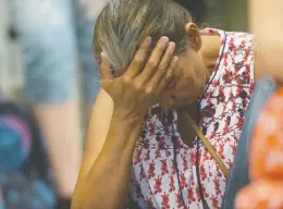  ?? DAVID BLOOM / POSTMEDIA NEWS FILES ?? Survivor Priscilla Cardinal holds her head as then-premier Rachel Notley apologized
to survivors and families of the Sixties Scoop at the Alberta Legislatur­e in 2018.