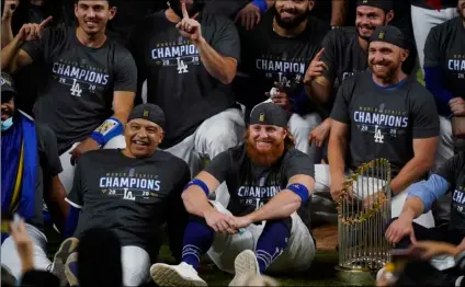  ?? AP Photo/Eric Gay ?? Los Angeles Dodgers manager Dave Roberts and third baseman Justin Turner pose for a group picture after the Dodgers defeated the Tampa Bay Rays 3-1 in Game 6 to win the baseball World Series, on Tuesday in Arlington, Texas.