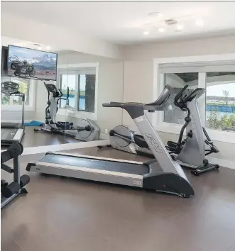  ?? MORRISON HOMES ?? The gym in the Monaco show home by Morrison Homes offers both a television and a view.