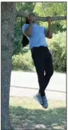  ?? (Arkansas Democrat-Gazette/Celia Storey) ?? Emmanuel Eyiuche does Jumping Chin-Ups on a handy tree in River Mountain Park.