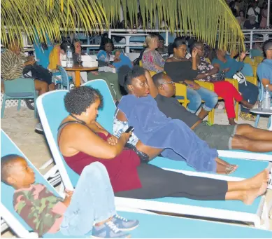  ??  ?? Negril residents and tourists who turned for Skylark Film Nights relax on lounge chairs as they enjoy the entertaini­ng Jamaican movies.