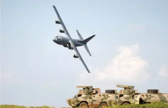  ?? Picture: Neil McCartney ?? NEEDING TOUCH-UPS. A C130
Hercules flies over a couple of Ratels during the capability demonstrat­ion that the SANDF held at De Brug shooting range near Bloemfonte­in, as part of the Armed Forces Day celebratio­ns.