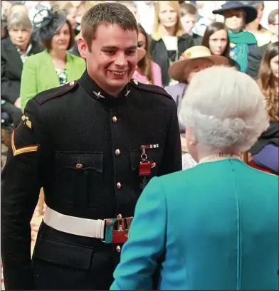  ??  ?? Well done! The Queen yesterday congratula­ting Josh Leakey, the second in his family to win a VC