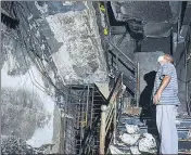  ??  ?? A man inspects the damage caused by a major fire at a hospital in Thane on Wednesday.