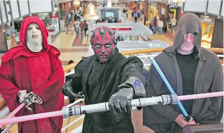  ?? PICTURE: DAVID RITCHIE ?? DEVOTED: Star Wars super fans Matthew Awood (Darth Sidious), Paul Wener (Darth Maul) and Brett Wener (Obi-Wan) dressed up as characters from the Star Wars movie franchise.