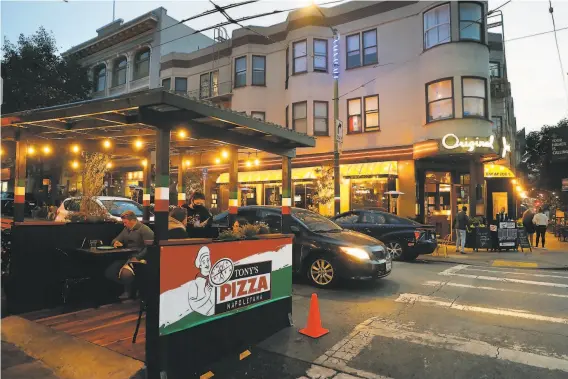  ?? Photos by Scott Strazzante / The Chronicle ?? Outdoor dining has helped restaurant­s survive in San Francisco’s North Beach. The neighborho­od may soon be adding parklets to replace parking spaces.