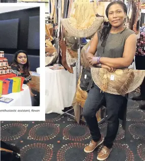  ?? PHOTOS BY PAUL H. WILLIAMS ?? Michelle Brown, CEO of REGGAETAW, makers of coal-roasted, spiced and pickled salt fish, looks on as her enthusiast­ic assistant, Kevan Malcolm, holds aloft bags of her products. Sabrina Reynolds, owner, and designer at SMR Leather Design Ja, showcasing some of her products.