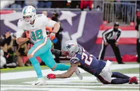  ?? ELISE AMENDOLA/AP PHOTO ?? Miami Dolphins tight end Mike Gesicki, left, catches the winning touchdown pass in front of New England Patriots safety Patrick Chung in the second half of Sunday’s game at Gillette Stadium in Foxborough, Mass.