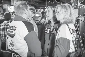  ?? JEFF MCINTOSH THE CANADIAN PRESS ?? Dave King, left, and Linda King, right, son and daughter of Frank King, CEO of the 1988 Winter Games, wearing ’88 Calgary Olympic jackets react to the results of the plebiscite.