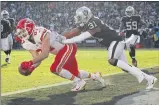  ?? Ezra Shaw / Getty Images ?? Kansas City’s Travis Kelce catches his second touchdown pass of the game against Oakland during the Chiefs’ 40-33 win over the Raiders in Oakland on Sunday. Kelce caught 12 passes for 168 yards in the game