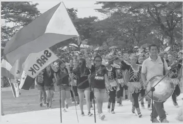  ?? JOY TORREJOS ?? Participan­ts to the yearly Sarok Festival parade at the streets Friday as one of the highlights of the 94th founding anniversar­y of the town of Consolacio­n.