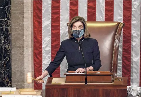  ?? J. Scott Applewhite / Associated Press ?? Speaker of the House Nancy Pelosi, D-calif., gavels in the final vote of the impeachmen­t of President Donald Trump on Wednesday at the Capitol. Trump was impeached for his role in inciting an angry mob to storm the Capitol last week.