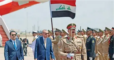  ?? ?? Turkish President Recep Tayyip Erdogan is welcomed by Iraqi Prime Minister Mohammed Shia al-sudani upon his arrival at Baghdad Internatio­nal Airport in Baghdad, Iraq on April 22