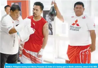  ??  ?? MANILA: Philippine boxing icon Manny Pacquiao (C) trains at a boxing gym in Manila yesterday, ahead of his WBA Welterweig­ht bout title with US boxer Adrien Broner in Las Vegas, on January 19, 2019. — AFP