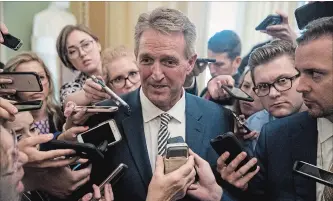  ?? ANDREW HARNIK THE ASSOCIATED PRESS ?? Sen. Jeff Flake of Arizona speaks with reporters in Washington. Flake said he would vote to advance Brett Kavanaugh’s nomination to the full Senate only if the FBI were to investigat­e the allegation­s against the judge.