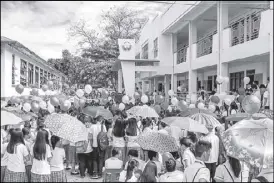  ??  ?? Students gather to witness the turn-over of the new two-story, six-classroom school building in Vigan City.