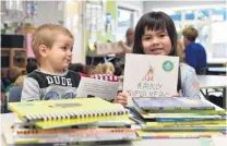  ?? PHOTO: GREGOR RICHARDSON ?? Read all about it . . . Rainbow Preschool pupils Henry Third (2) and Mia Tuilaepa (4) look at some of the new books given to the early learning centre by the Communitie­s of Readers Project.