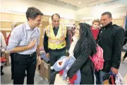  ?? REUTERS ?? Syrian refugees are greeted by Canada’s Prime Minister Justin Trudeau, left, on arrival at Toronto Pearson Internatio­nal Airport in Ontario, Canada, yesterday.