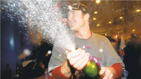  ?? JED JACOBSOHN/GETTY IMAGES ?? Chase Utley #26 of the Philadelph­ia Phillies sprays champagne in the locker room as he celebrates their 4-3 win to win the World Series against the Tampa Bay Rays during the continuati­on of game five of the 2008 MLB World Series on October 29, 2008 at Citizens Bank Park in Philadelph­ia, Pennsylvan­ia.