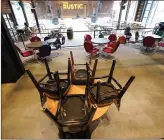  ?? AP Photo/David J. Phillip ?? Chairs are stacked on a table Friday inside The Rustic, in Houston. The restaurant and bar will be limited to 50 per cent capacity after Texas Gov. Greg Abbott announced Friday he is shutting bars and scaling back restaurant capacity in response to COVID-19 cases.