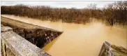  ?? MIAMI CONSERVANC­Y DISTRICT PHOTO ?? Lockington Dam, in Shelby County, holds back water on Dec. 22, 2013. The Miami Conservanc­y District system of dams protects towns up and down the region’s drainage basin.