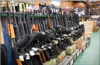  ?? ROBERT F. BUKATY - THE ASSOCIATED PRESS FILE ?? Assault rifles at Coastal Trading and Pawn on July 18in Auburn, Maine. President Joe Biden pushed a weapons ban nearly everywhere that he campaigned this year.