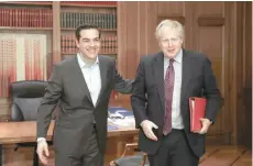  ?? — Reuters ?? Greek Prime Minister Alexis Tsipras welcomes British Foreign Secretary Boris Johnson at his office in the Maximos Mansion in Athens on Friday.