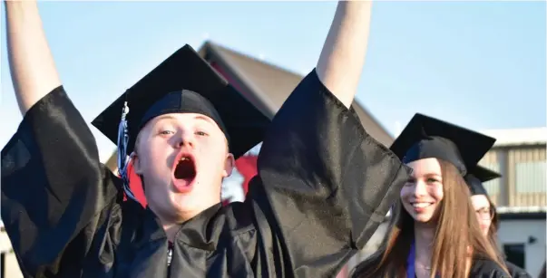  ?? ?? A White Hall graduate is excited during the opening march.