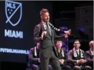  ?? LYNNE SLADKY — THE ASSOCIATED PRESS FILE ?? In this file photo, David Beckham speaks at an event announcing that Major League Soccer is bringing an expansion team to Miami, in Miami. The team is backed by Beckham and a team of investors. Beckham is described as a good taste ambassador by...