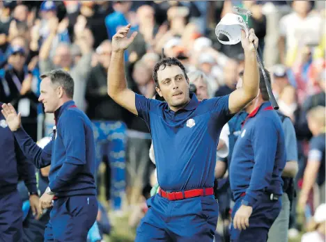  ?? PHOTOS: MATT DUNHAM/THE ASSOCIATED PRESS ?? Europe’s Francesco Molinari celebrates after winning a foursome match with his partner Tommy Fleetwood over the American team of Justin Thomas and Jordan Spieth Friday at the 42nd Ryder Cup matches at Le Golf National located outside Paris.
