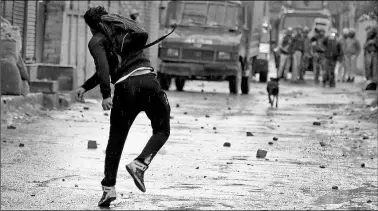  ?? PTI ?? A student throws stones on security forces during a protest in Srinagar on Saturday.