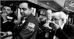  ?? RICHARD DREW/AP ?? New York Stock Exchange investors hold on as the market takes an early tumble Friday.