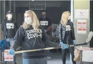  ?? TIJANA MARTIN THE CANADIAN PRESS FILE PHOTO ?? Olympian Hayley Wickenheis­er joins Conquer COVID-19 volunteers at a donation drive for personal protective equipment at XYZ Storage in Toronto in early April.