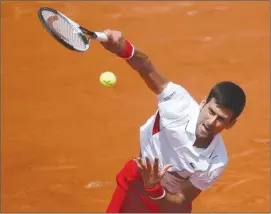  ?? The Associated Press ?? Serbia’s Novak Djokovic serves against Spain’s Jaume Munar during their second-round match at the French Open in Paris, France, on Wednesday.