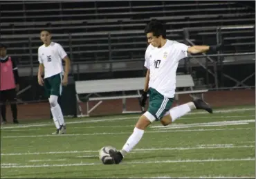  ?? Haley Sawyer/The
Signal ?? Canyon boys soccer’s Josh Roque dribbles the ball down the field against Calabasas on Friday night at Canyon. Roque scored the second goal in the Cowboys’ 2-0 win over the Coyotes. It was the team’s first home win since the 2015-16 season.